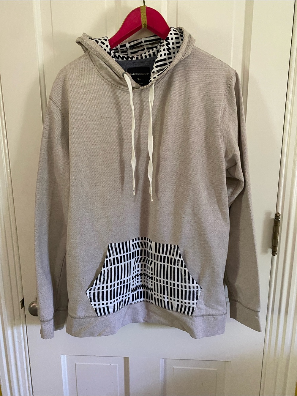 Modern Amusement Light Gray Hoodie with Black & White Patterned Pocket